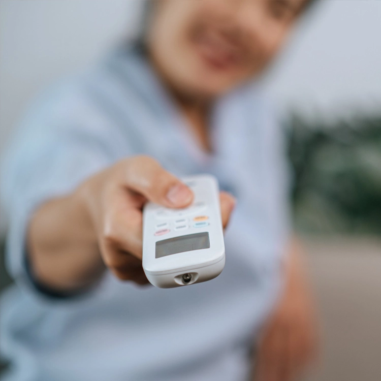 Technician using AC remote
