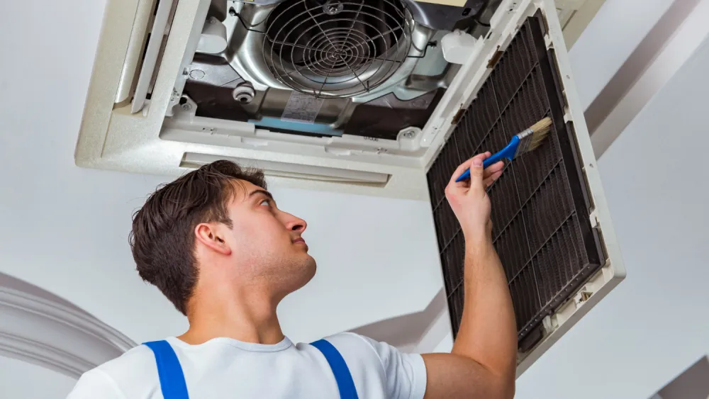 Technician servicing an air conditioner